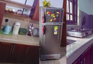 a kitchen with a refrigerator with magnets on it at Q3 Homestay in Athurugiriya
