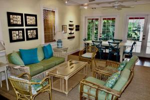 a living room with a couch and chairs and a table at Ashe Splashe in Key West