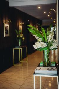 a vase of flowers sitting on top of a table at The Chesterton Hotel in Bicester