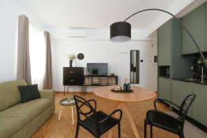 a living room with a couch and a table at Residence Degli Aranci - Casêta in Ancona