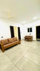 a living room with a couch and a table at Coastal Bliss Appartments in Varkala