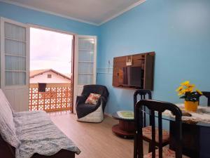 a blue living room with a table and a chair at Caeté in Torres