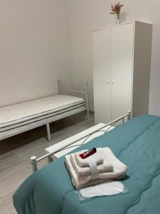 a bedroom with a bed with a towel on it at Casa Vacanza Rosati in Cerignola