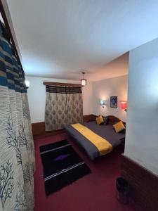 a bedroom with a large bed in a room at Basecamp Manali in Manāli +11 photos
