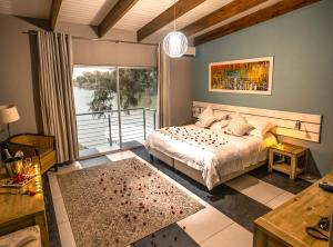 a bedroom with a bed and a large window at Broadwater River Estate in Douglas +70 photos