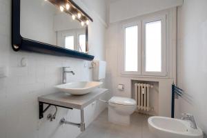 a bathroom with a sink and a toilet and a mirror at Appartamento Margherita in Venice +10 photos