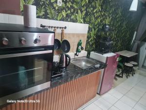 a kitchen with a stove and a sink at Mountain View at The Edge in Cimindi-hilir