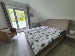 a bedroom with a bed and a window at Meine Zeit in Cuxhaven
