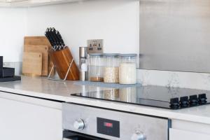 a kitchen with a counter top with ingrediantsyrics at 1Bed Gem, Quick Access to Windsor, Central London in Slough