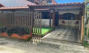 a gazebo with a fence and a patio at Casa temporada Monsuaba in Angra dos Reis