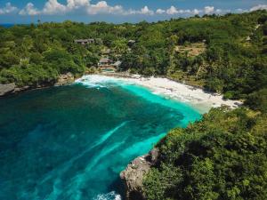 an aerial view of a beach with turquoise water at Villa Searra - Ocean Breeze Boutique Hotel Hideaway Rooms in Canggu