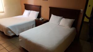 Postel nebo postele na pokoji v ubytování Hotel La Posta + 6 fotografií
