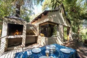 a stone house with a fireplace and a table with plates at Broadwater River Estate in Douglas