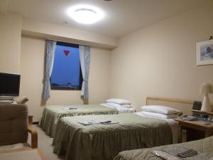 Postel nebo postele na pokoji v ubytování Narita U-City Hotel