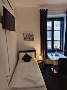 Postel nebo postele na pokoji v ubytování Hotel Bílý Koníček