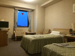 Postel nebo postele na pokoji v ubytování Narita U-City Hotel