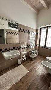 a bathroom with a tub and a sink and two toilets at BnBFuoriMilano in Rho +24 photos
