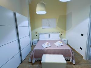a bedroom with a bed with two towels on it at Albachiara Apartment in Lampedusa +4 photos