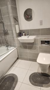 a bathroom with a sink and a toilet at Modern 2 Bedroom Apartment in Grays Thurrock