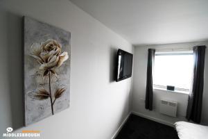 a room with a flower painting on the wall at Jayden House in Middlesbrough