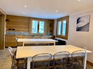 a room with two tables and chairs and windows at 4 Bedroom, 4 Bathroom, Hot Tub, Chamonix Centre in Chamonix-Mont-Blanc