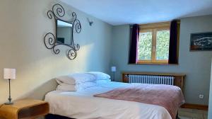 a bedroom with a bed and a window at 4 Bedroom, 4 Bathroom, Hot Tub, Chamonix Centre in Chamonix-Mont-Blanc