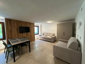 a living room with a couch and a table at Colere Ski e Trekking 714 e 715 in Colere