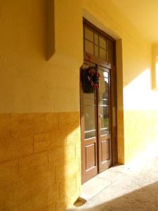 a door of a building with a wreath on it at Ergzotic Apartments & Room in Sombor