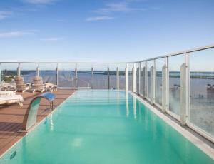 a swimming pool on the roof of a building at Puerto Norte Design Hotel in Rosario