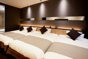 Postel nebo postele na pokoji v ubytování Hotel Risveglio Akasaka