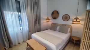 Łóżko lub łóżka w pokoju w obiekcie Casa du Soleil Hostal Boutique