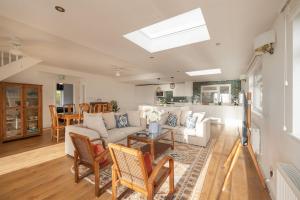 a living room with a couch and a table at Luxury Cornish Seaview Bungalow in Looe