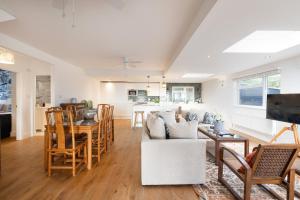 a living room with a white couch and a table at Luxury Cornish Seaview Bungalow in Looe