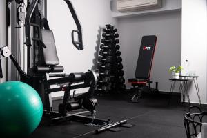 a gym with two tread machines and an exercise ball at Athenian Riviera Hotel& Suites in Athens