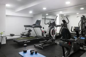 a gym with several exercise bikes in a room at Athenian Riviera Hotel& Suites in Athens