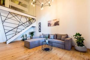 a living room with a couch and a table at Aigli Seafront Loft-Luxury Design Retreat in Kalamata