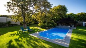 a backyard with a swimming pool and a gazebo at Glen Avon Lodge Boutique Hotel in Cape Town