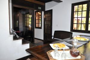 a dining room with a table with a plate of food on it at Quinta O Refúgio in São Vicente