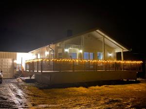a house with lights on the side of it at night at Brygghaugen, middle of Senja in Senja