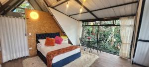 a bedroom with a bed and a large window at Hostal Fisterra in Moniquirá