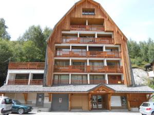 a large wooden building with a large balcony at Studio confortable avec grand balcon aux Deux Alpes - FR-1-516-87 in Les Deux Alpes