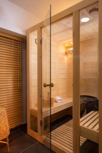 a sauna with a glass door in a room at Athenian Riviera Hotel& Suites in Athens