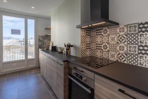 a kitchen with a black counter top and a window at T3 lumineux à 2 pas de la gare in Marseille +11 photos