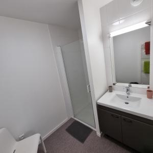 a white bathroom with a shower and a sink at Résidence NOVAGE - Amiens in Amiens +22 photos
