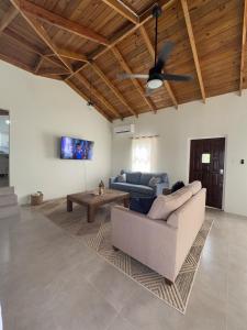a living room with a couch and a ceiling fan at Villa La Mer Ocean View Marisule Ridge in Gros Islet +41 photos