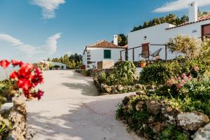 a white house with flowers in front of it at Casa Las Carballas Isabel in Icod de los Vinos