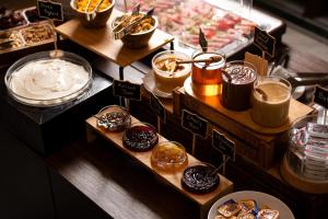 a display of donuts and other pastries in a bakery at Athenian Riviera Hotel& Suites in Athens