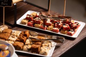a table with two trays of food on top at Athenian Riviera Hotel& Suites in Athens