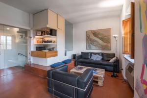 a living room with a couch and a table at Il Villino Del Collezionista With Pool, Pistoia in Pistoia