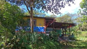 a house with a colorful paint on it at Casa Refugio LA TEBAIDA in Mocoa